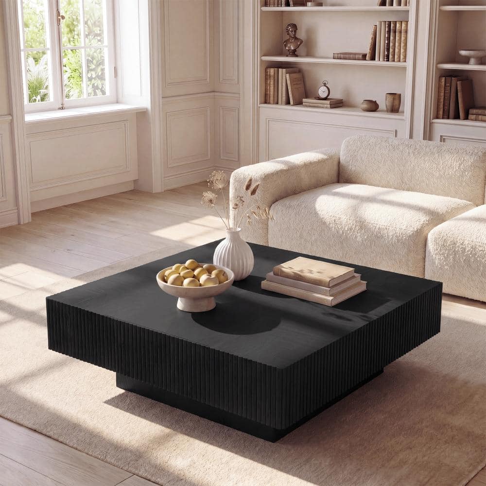 Dark wood coffee table styled in a living room.