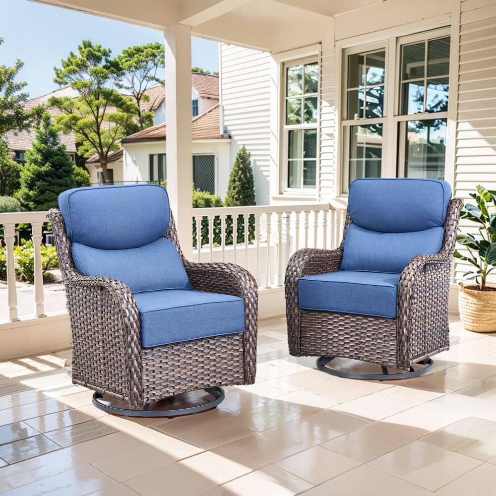 Two brown wicker swivel glider outdoor lounge chairs with navy blue cushions.