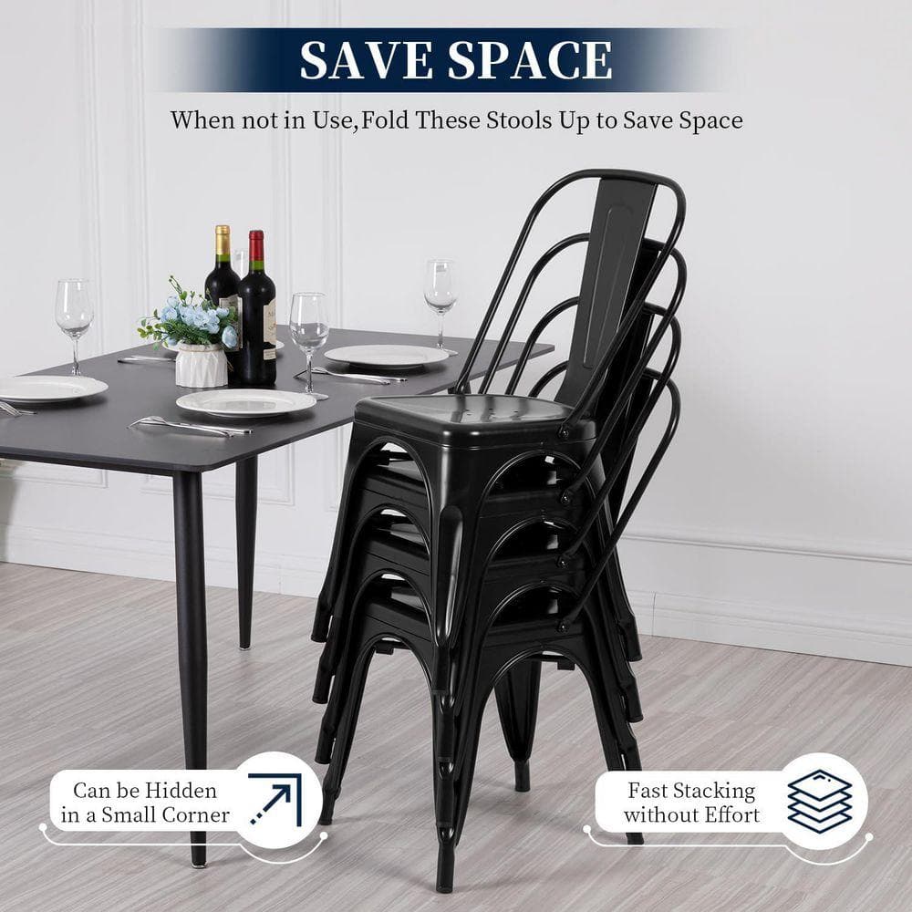 Four black metal dining chairs stacked together.