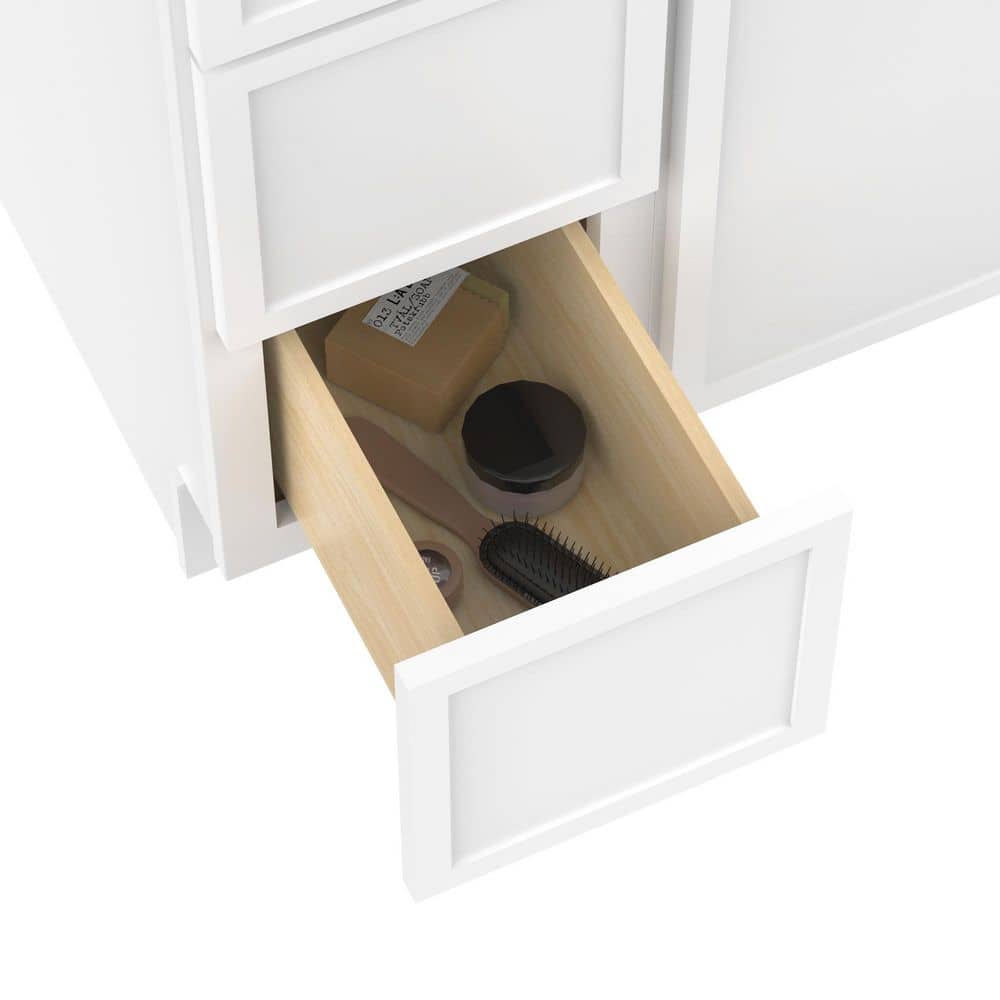 Close-up of an open drawer in a white bathroom vanity cabinet.