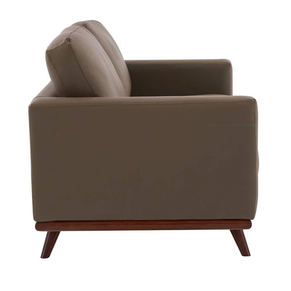 Taupe leather loveseat sofa with a pillow.