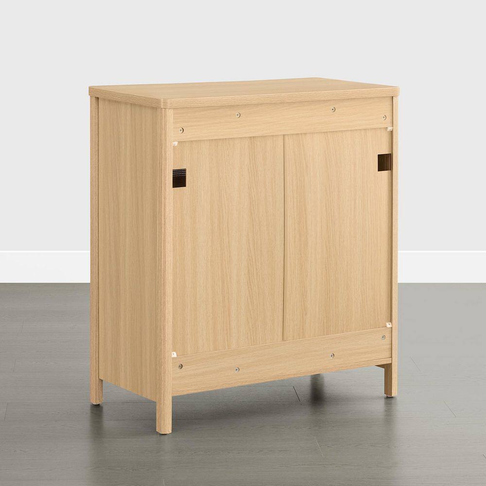 Rear view of an oak wood sideboard showing dual cord management cutouts.