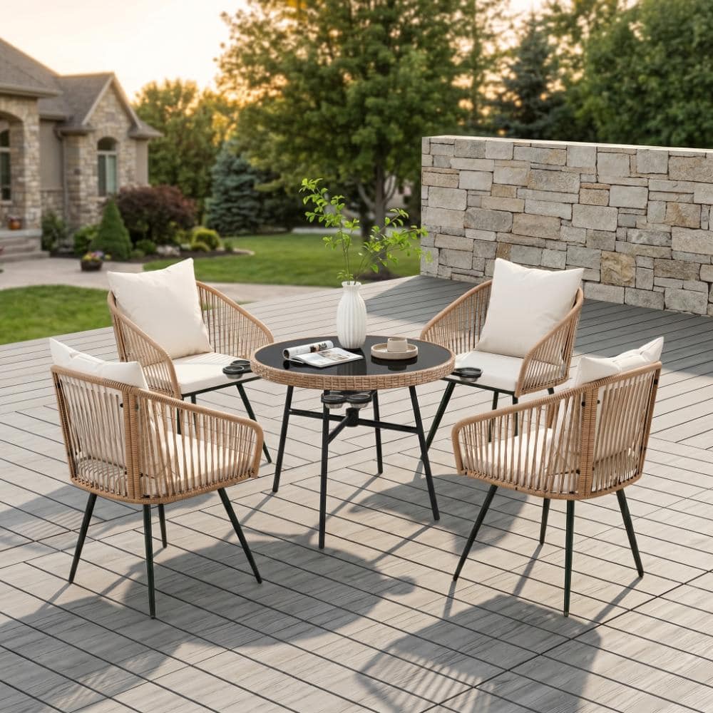 Outdoor dining set on a wooden deck during sunset.