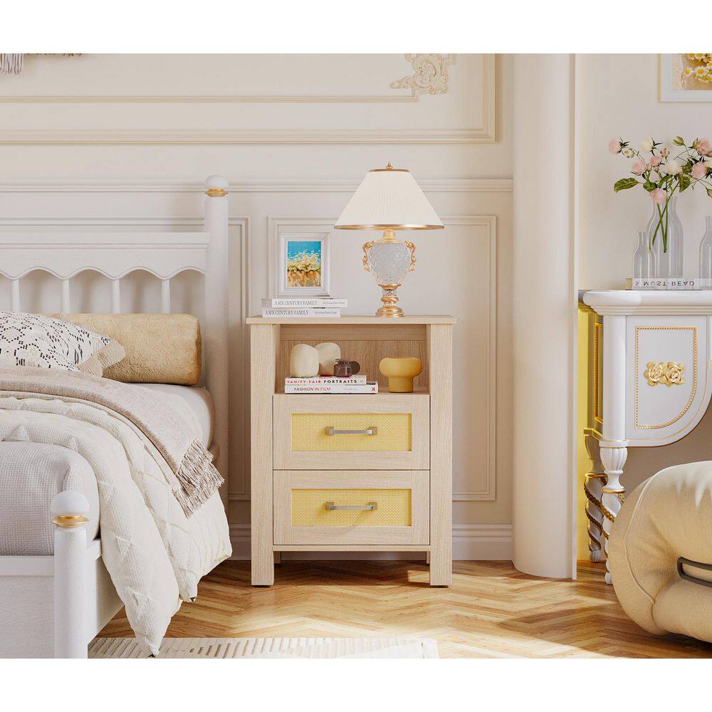 Natural wood rattan nightstand with two drawers in a bedroom setting.