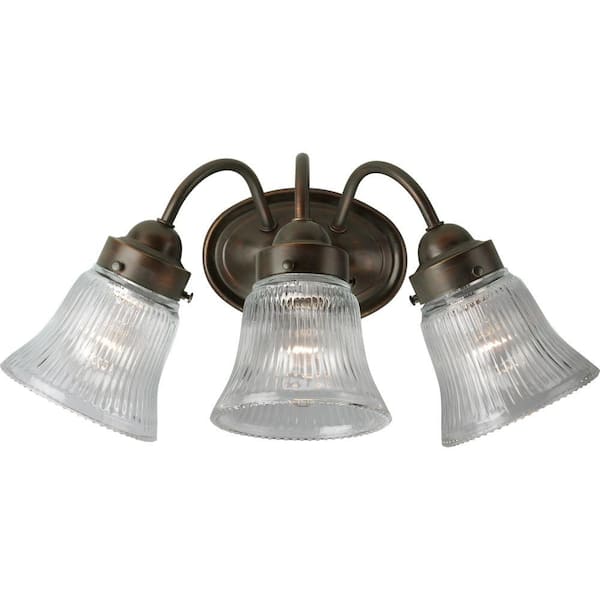 Progress Lighting Fluted Glass Collection 3-Light Antique Bronze Clear Prismatic Glass Traditional Bath Vanity Light