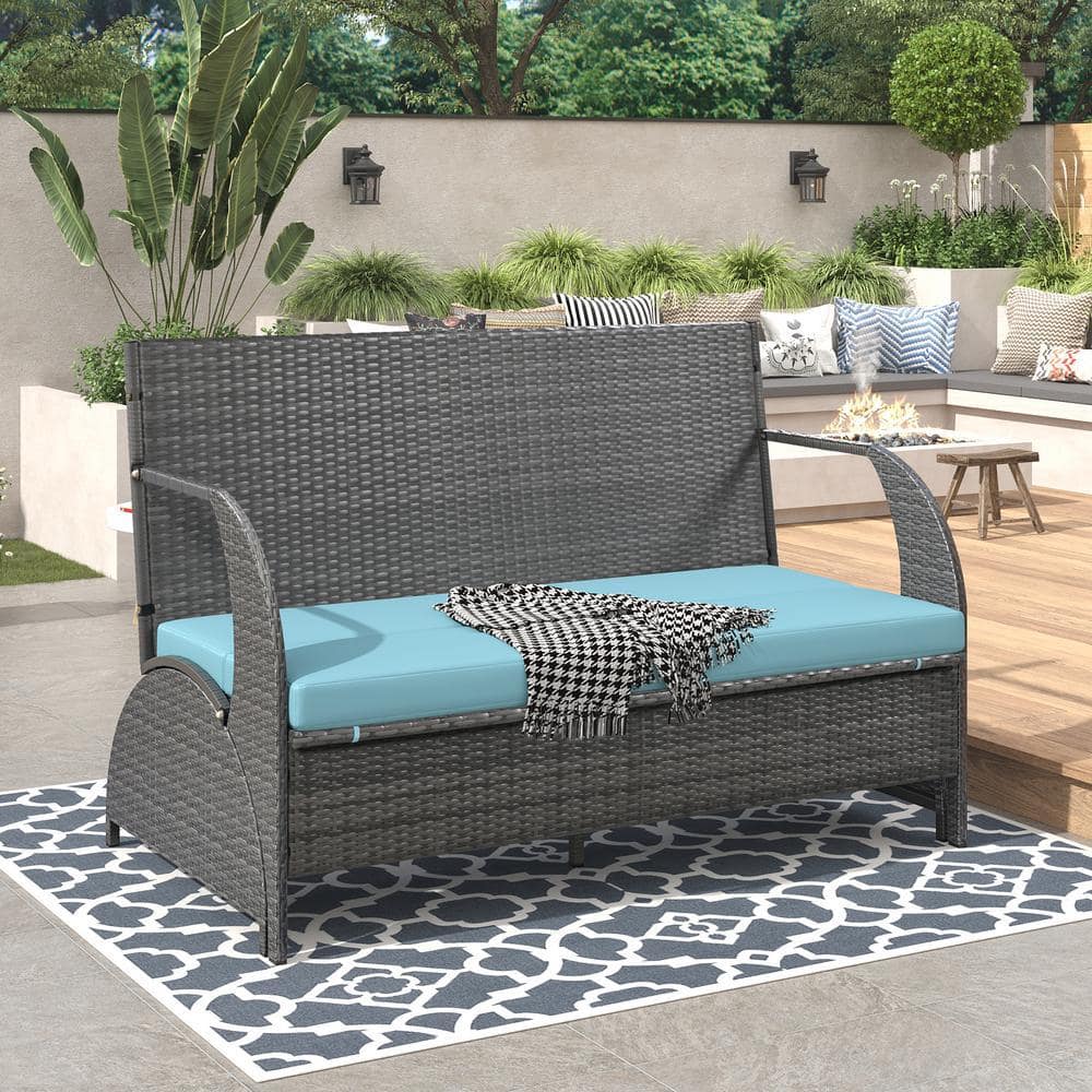 Outdoor conversation set with blue cushions in a lifestyle setting.
