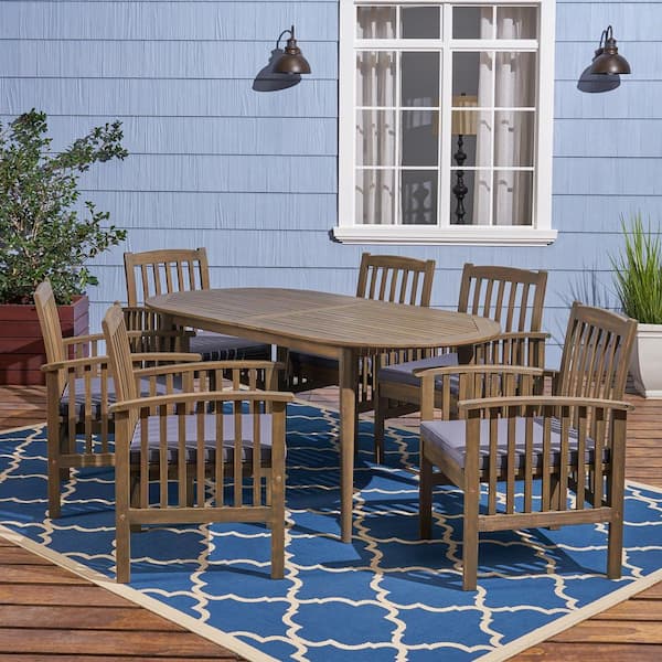 Noble House Casa Acacia Grey 7-Piece Acacia Wood Oval Table with Straight Legs Outdoor Patio Dining Set with Dark Grey Cushions