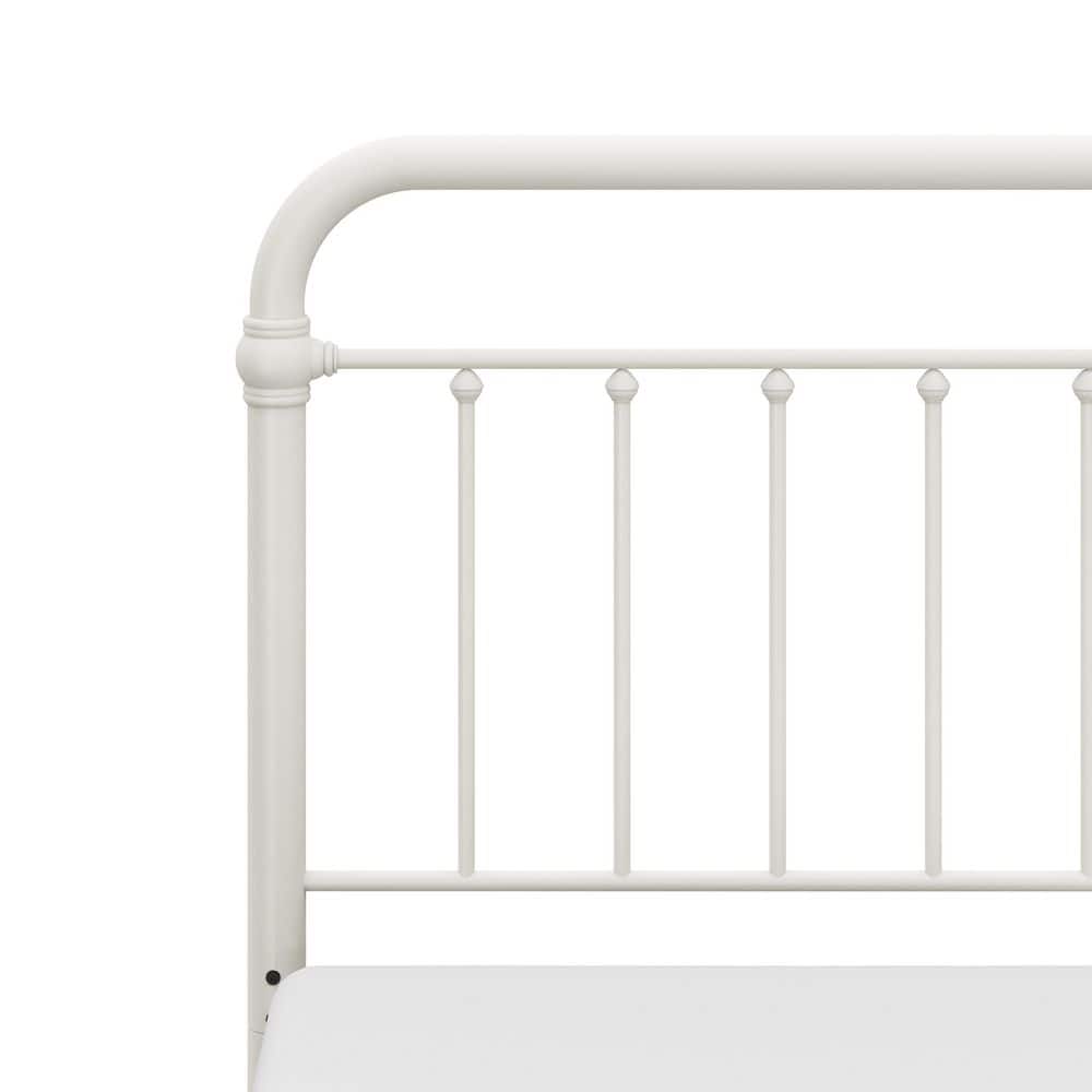 Close-up of the white metal headboard spindles and top rail.