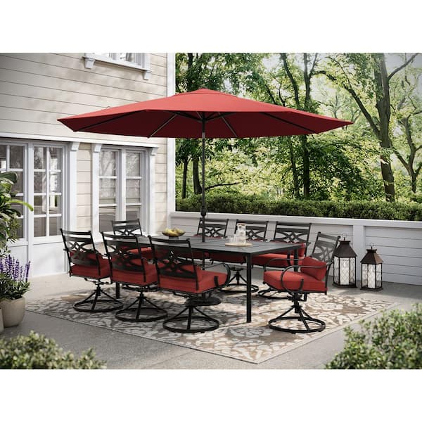 Hanover Montclair 9-Piece Steel Outdoor Dining Set with Chili Red Cushions, 8 Swivel Rockers, 42 in. x 84 in. Table and Umbrella