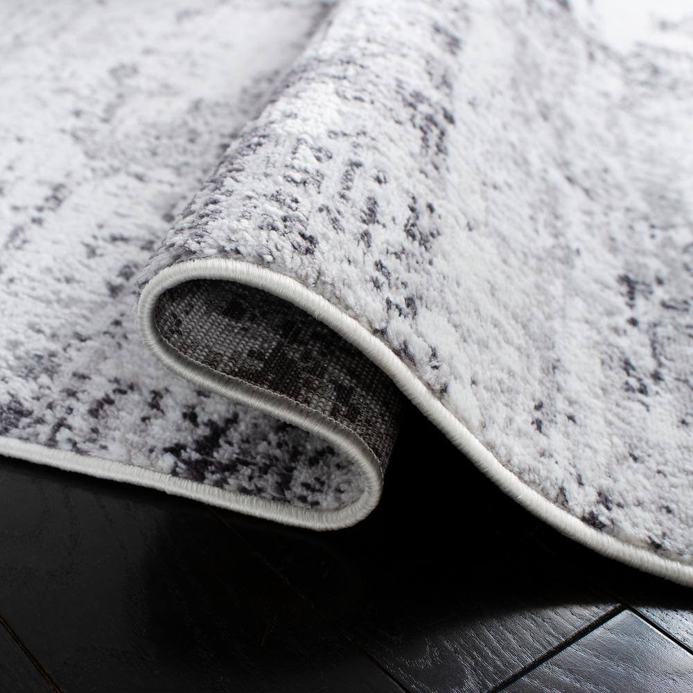 Ivory and Grey Abstract Round Synthetic Rug, 3' x 5'