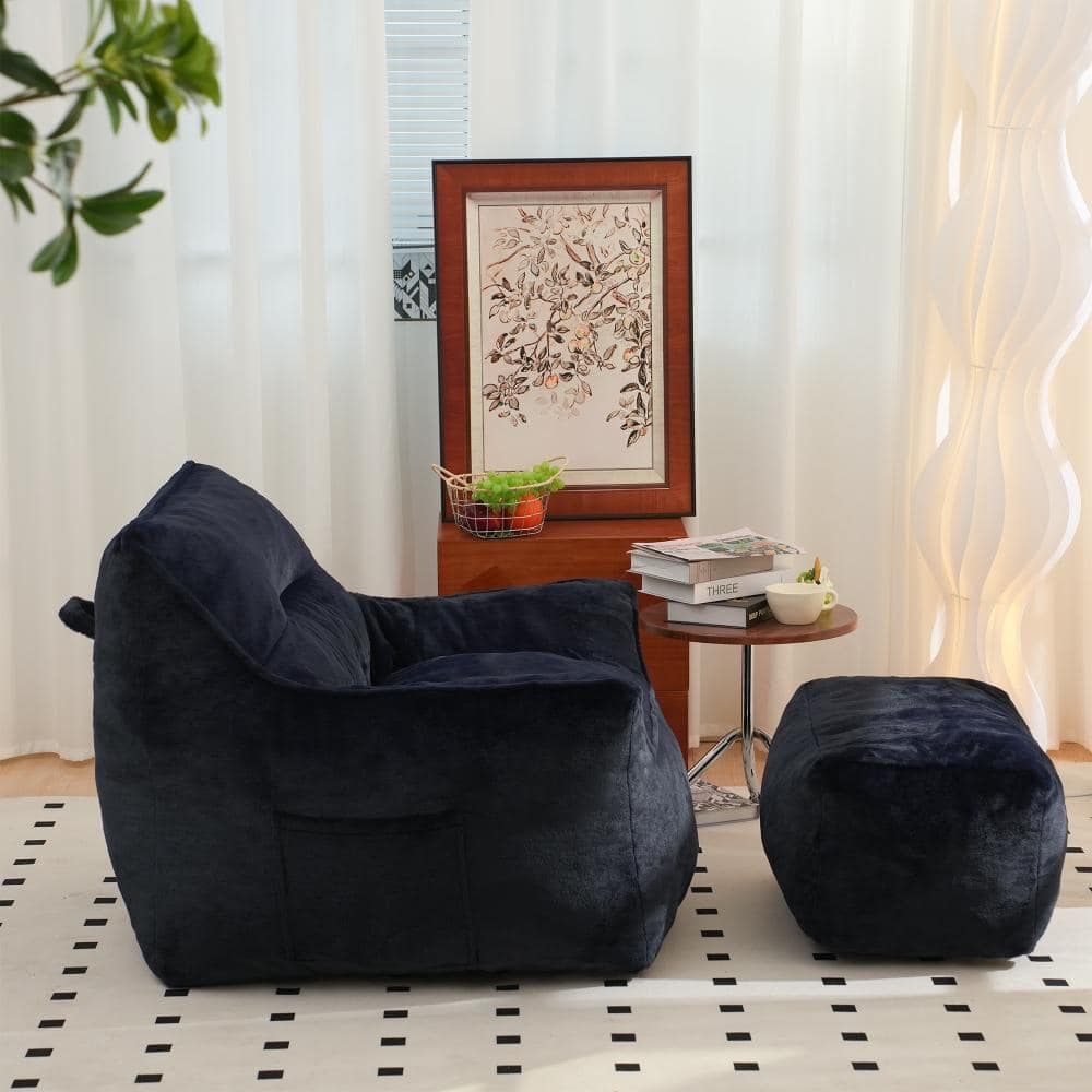 Navy blue bean bag chair and ottoman in a modern living room setting.