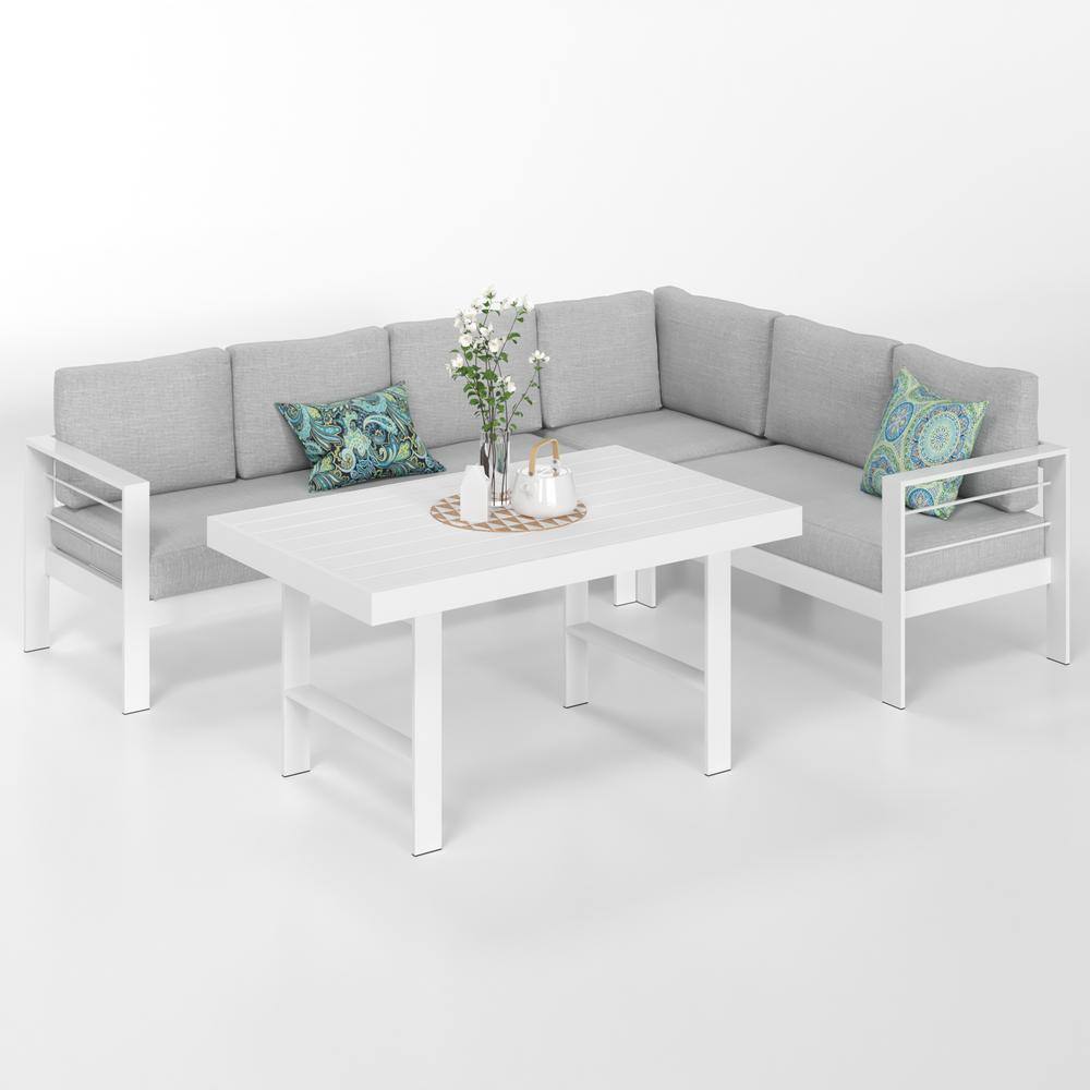 White 4-piece aluminum patio conversation set with light gray cushions and decorative pillows.
