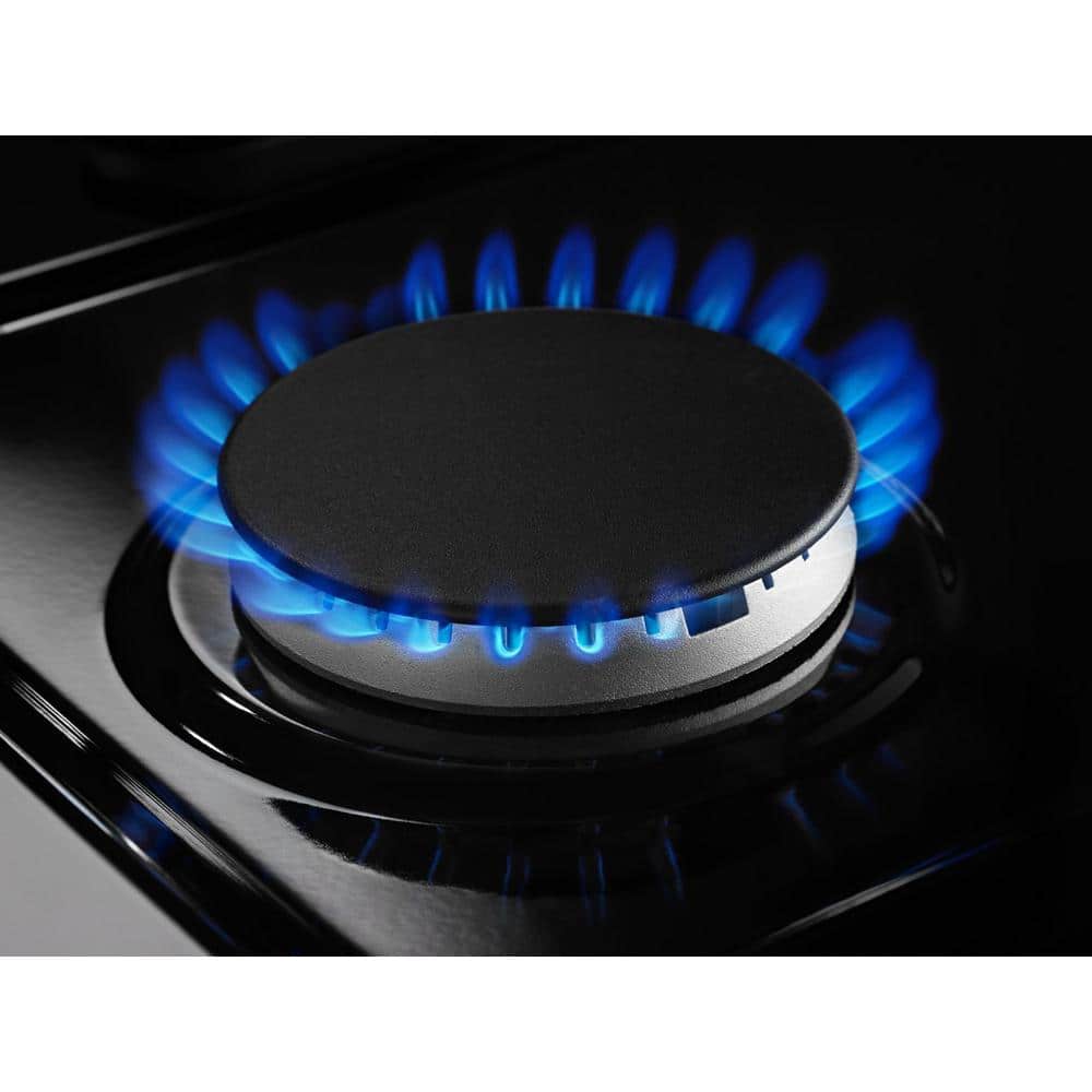Close-up of a gas burner with blue flame