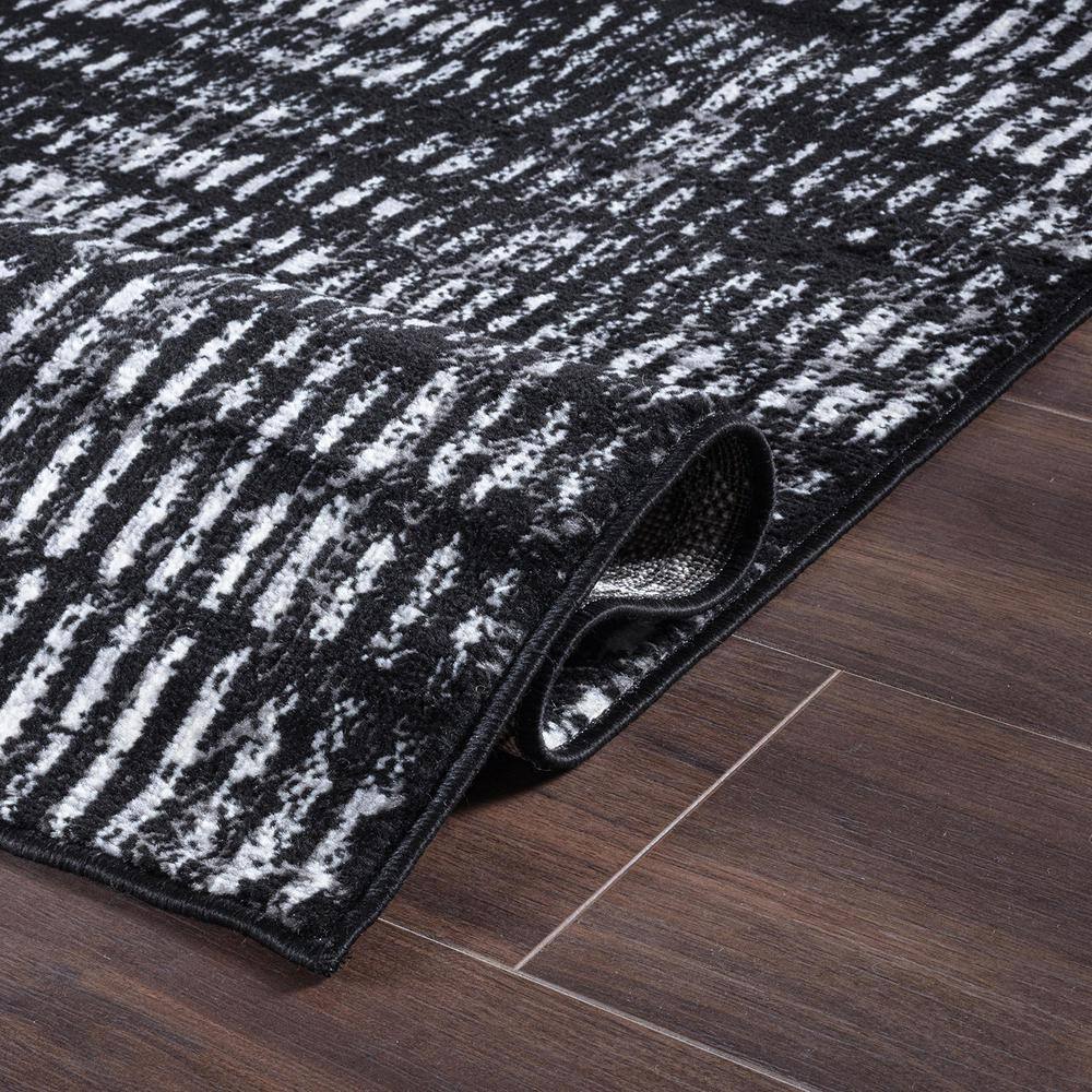 Black and Ivory Geometric Polypropylene Area Rug 2' x 7'