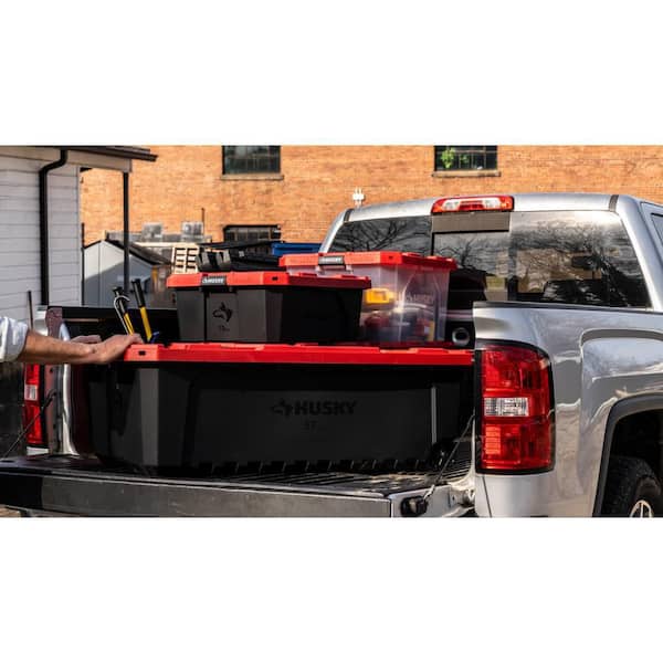 57 Gal. Pro Grip Storage Tote with Wheels in Black with Red Lid
