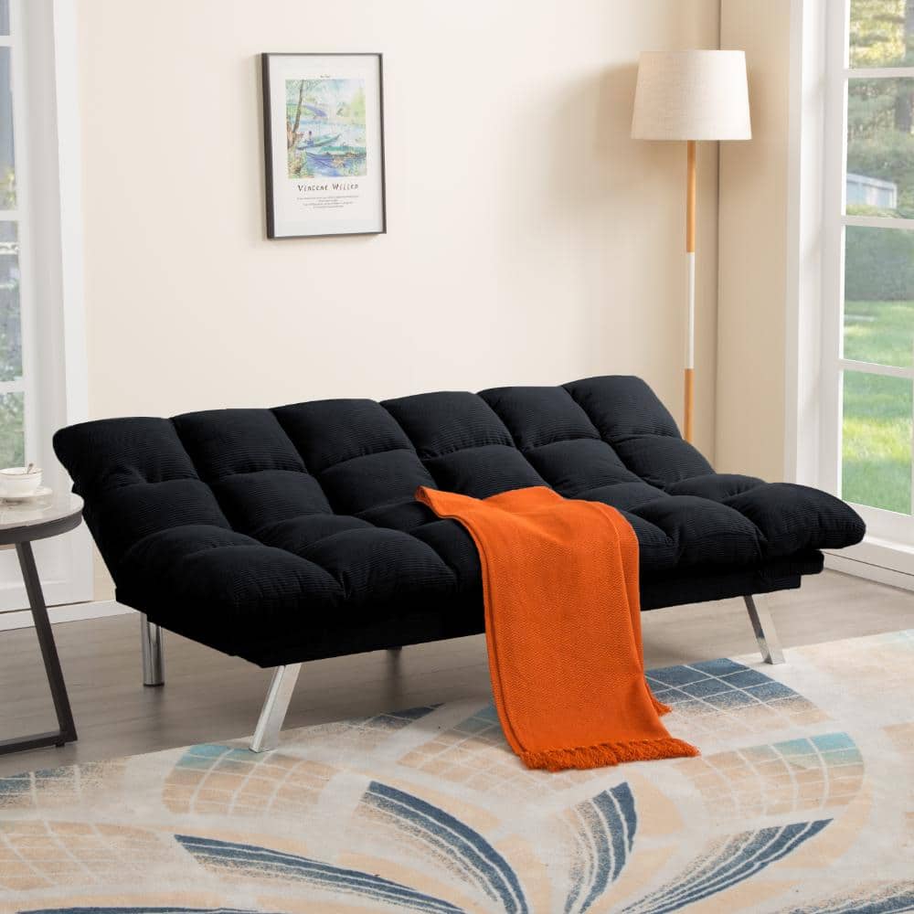 Black corduroy futon sofa bed with an orange throw blanket.