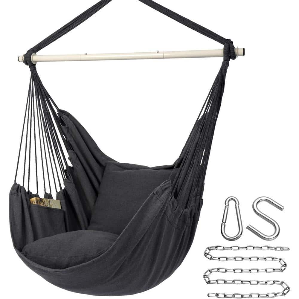 Black hammock chair with wooden spreader bar and cushions.