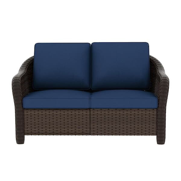 Dark Brown Wicker Outdoor Loveseat with Stylish Curved Arms and Plush Blue Cushions