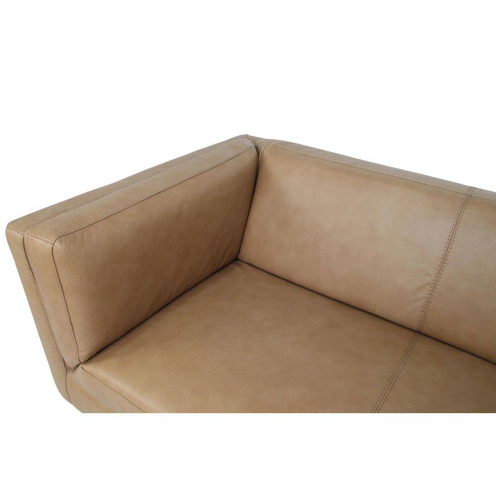 Close-up detail of the armrest and seat of a tan leather sofa.