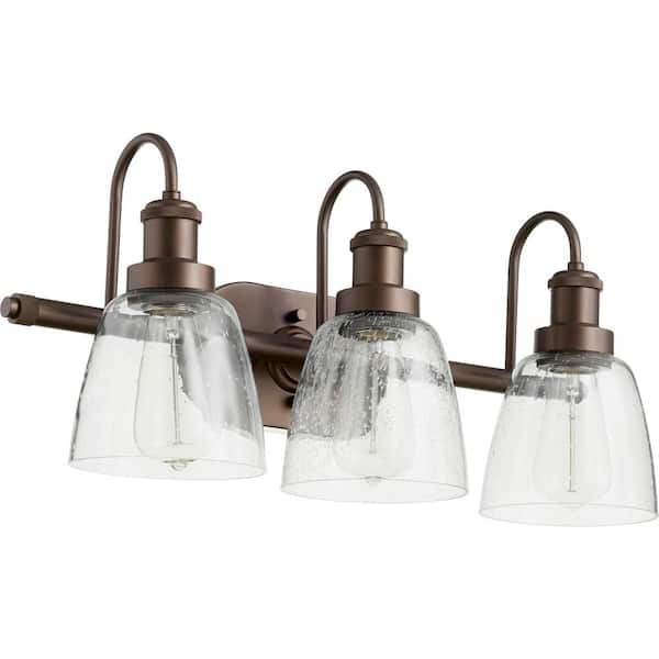 Quorum INTERNATIONAL Hollis Transitional, 24 in. Width in. 3-Lights Aged Brass Vanity Lights with Seeded Glass Shade