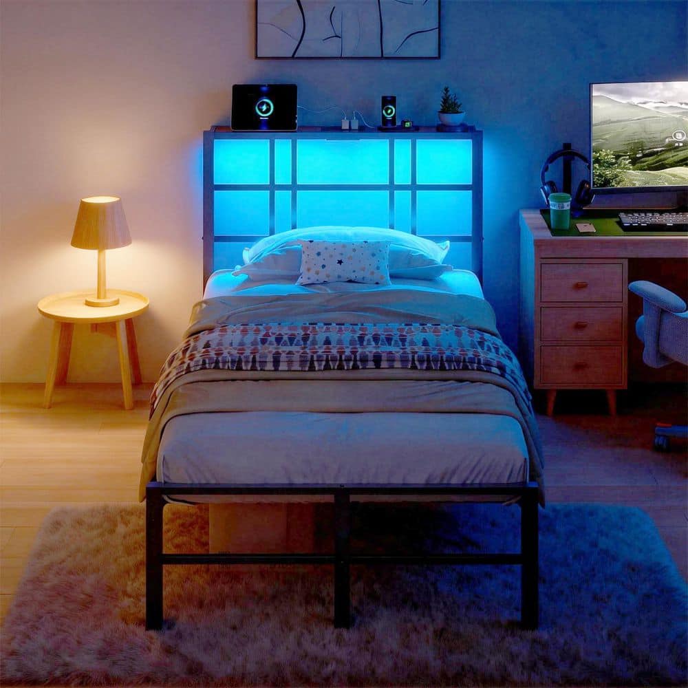 Black metal twin platform bed with blue LED lights in a bedroom.